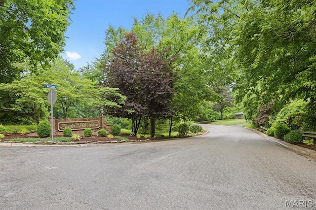 101 E Fairway Dr, Belleville, IL 62223 - view of asphalt road featuring curbs, traffic signs, and view of wooded area