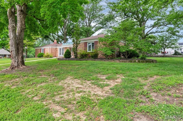 10 Rio Vista Dr, Frontier Township, MO 63303 - view of front of property with a chimney, brick siding, and a front lawn