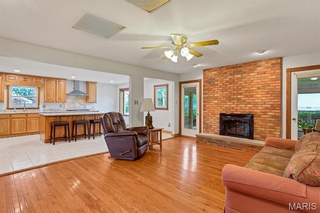 10 Rio Vista Dr, Frontier Township, MO 63303 - living room with light wood-style flooring, plenty of natural light, and a fireplace