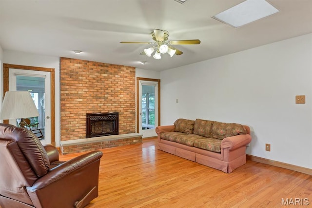 10 Rio Vista Dr, Frontier Township, MO 63303 - living area with healthy amount of natural light, light wood finished floors, a fireplace, and a ceiling fan