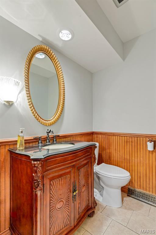 10 Rio Vista Dr, Frontier Township, MO 63303 - bathroom with a wainscoted wall, vanity, tile patterned flooring, and wood walls