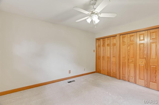10 Rio Vista Dr, Frontier Township, MO 63303 - unfurnished bedroom featuring light colored carpet, two closets, and a ceiling fan