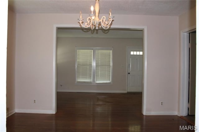 111 W Broadway St, Hayti, MO 63851 - unfurnished dining area with a chandelier and wood finished floors