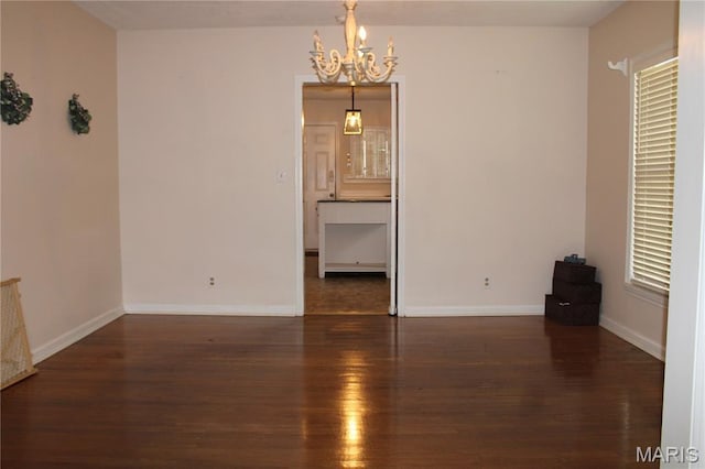111 W Broadway St, Hayti, MO 63851 - empty room with a chandelier and wood finished floors