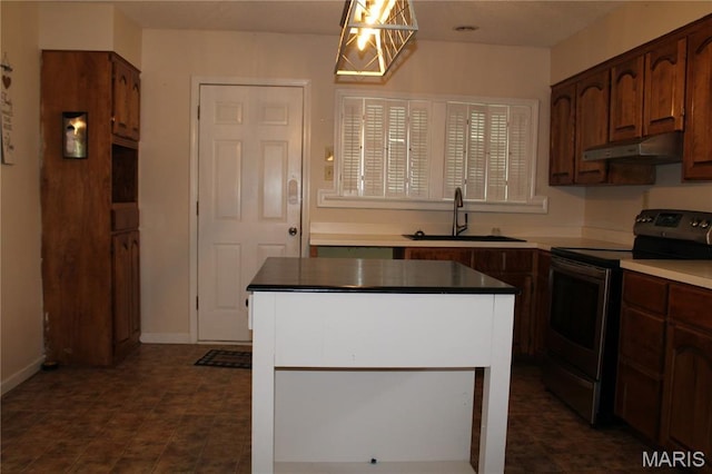 111 W Broadway St, Hayti, MO 63851 - kitchen with stainless steel electric range oven, under cabinet range hood, a center island, and pendant lighting