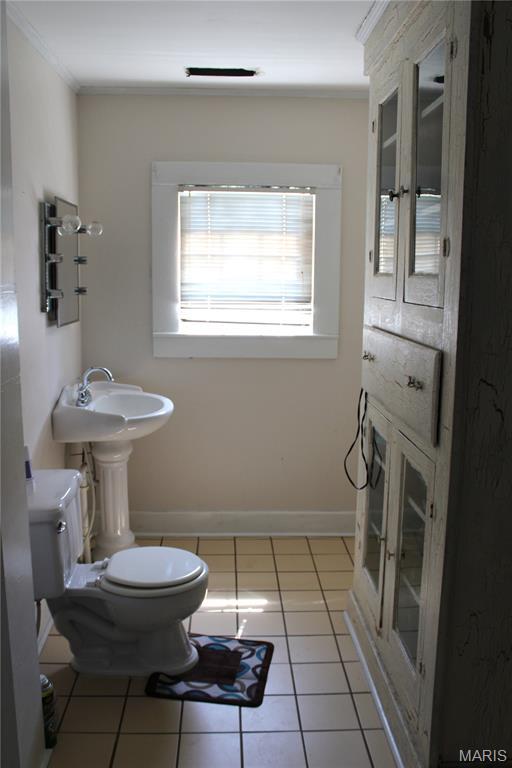 111 W Broadway St, Hayti, MO 63851 - bathroom with ornamental molding and tile patterned flooring