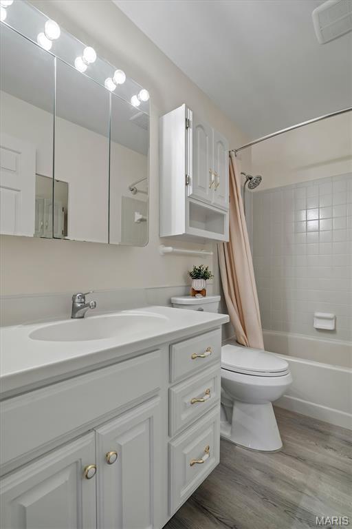 526 Sarah Ln Unit 13, Creve Coeur, MO 63141 - full bathroom featuring vanity, shower / bathtub combination with curtain, and wood finished floors