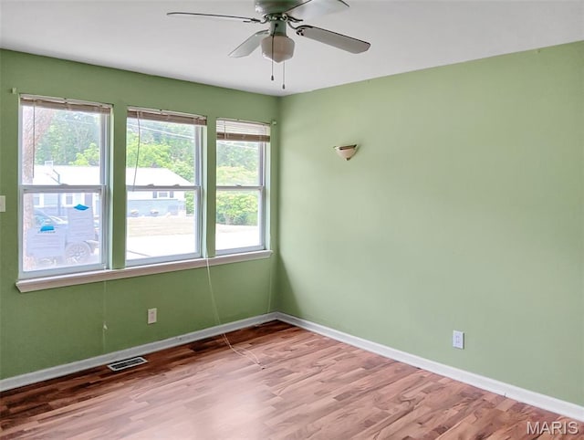 4664 Pogue Dr, House Springs, MO 63051 - empty room featuring plenty of natural light, light wood-style floors, and ceiling fan