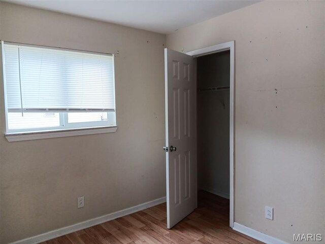 4664 Pogue Dr, House Springs, MO 63051 - unfurnished bedroom featuring wood finished floors and a closet