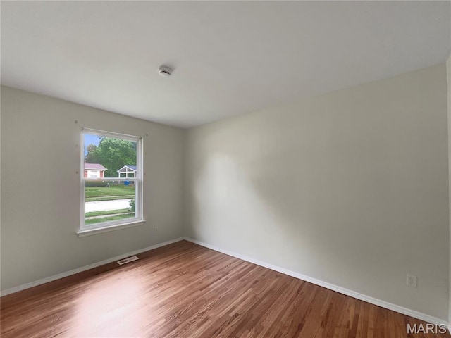 5031 Tulip Tree Ln, Hazelwood, MO 63042 - unfurnished room featuring wood finished floors and a smoke detector