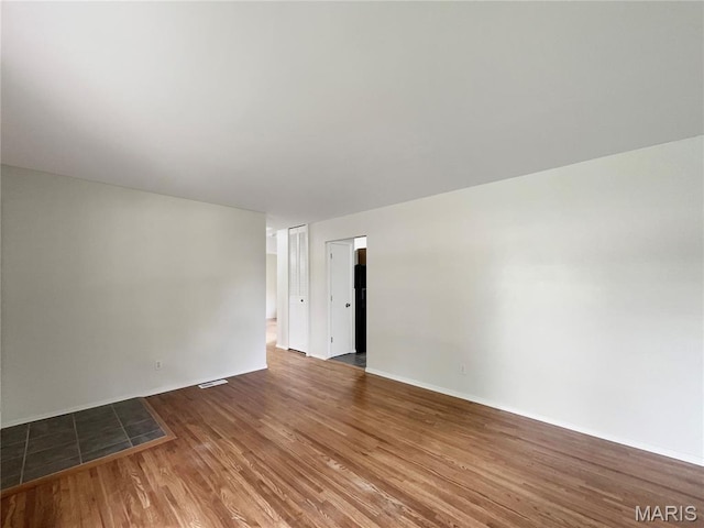 5031 Tulip Tree Ln, Hazelwood, MO 63042 - unfurnished room featuring wood finished floors and baseboards