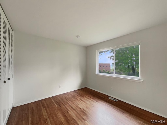 5031 Tulip Tree Ln, Hazelwood, MO 63042 - unfurnished bedroom with wood finished floors and a closet