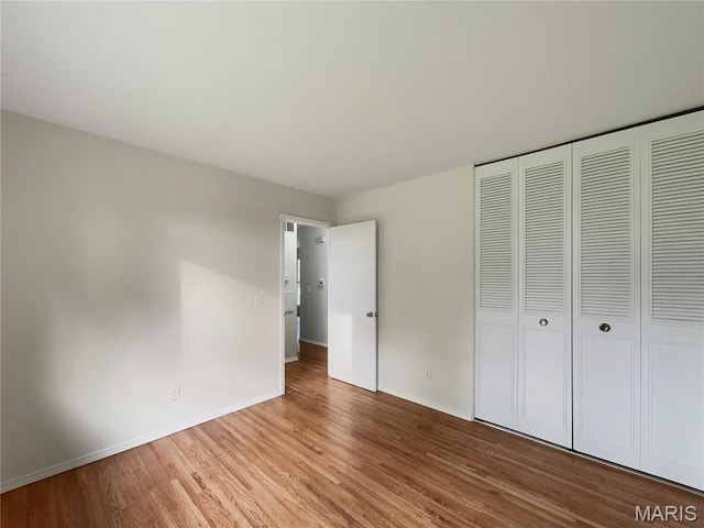 5031 Tulip Tree Ln, Hazelwood, MO 63042 - unfurnished bedroom with wood finished floors and a closet