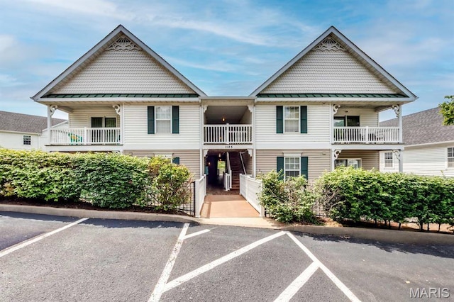1125 Arbor Creek Dr Unit 2D, Saint Louis, MO 63122 - view of front facade featuring a standing seam roof, uncovered parking, and a metal roof