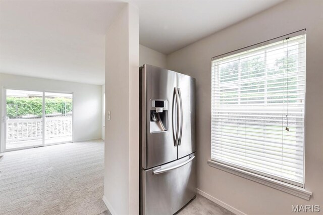1125 Arbor Creek Dr Unit 2D, Saint Louis, MO 63122 - kitchen featuring stainless steel fridge with ice dispenser and light colored carpet