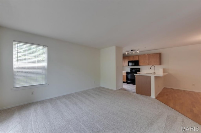 1125 Arbor Creek Dr Unit 2D, Saint Louis, MO 63122 - unfurnished living room with rail lighting and light carpet