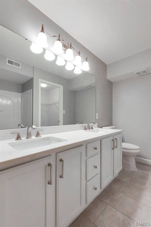 1125 Arbor Creek Dr Unit 2D, Saint Louis, MO 63122 - bathroom featuring double vanity and tile patterned floors