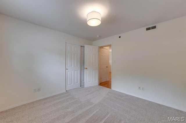 1125 Arbor Creek Dr Unit 2D, Saint Louis, MO 63122 - unfurnished bedroom featuring light carpet and a closet