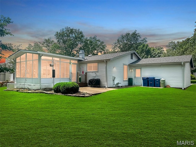15468 Hitchcock Rd, Chesterfield, MO 63017 - back of property at dusk featuring a sunroom and a yard