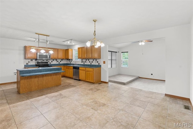 3779 Michael John Dr, Swansea, IL 62226 - kitchen with appliances with stainless steel finishes, ceiling fan, a center island, and pendant lighting