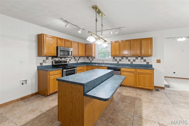 3779 Michael John Dr, Swansea, IL 62226 - kitchen featuring appliances with stainless steel finishes, dark countertops, brown cabinetry, and tasteful backsplash