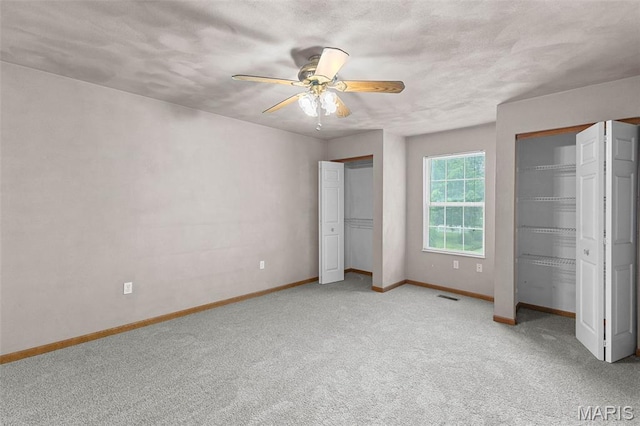3779 Michael John Dr, Swansea, IL 62226 - unfurnished bedroom featuring two closets, light carpet, and ceiling fan
