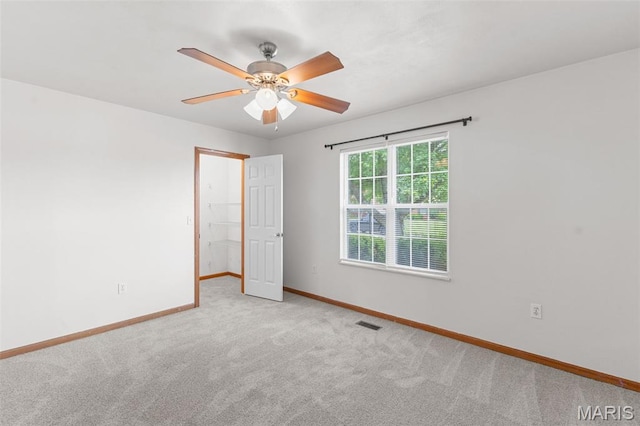 3779 Michael John Dr, Swansea, IL 62226 - unfurnished bedroom with carpet, a walk in closet, a ceiling fan, and a closet