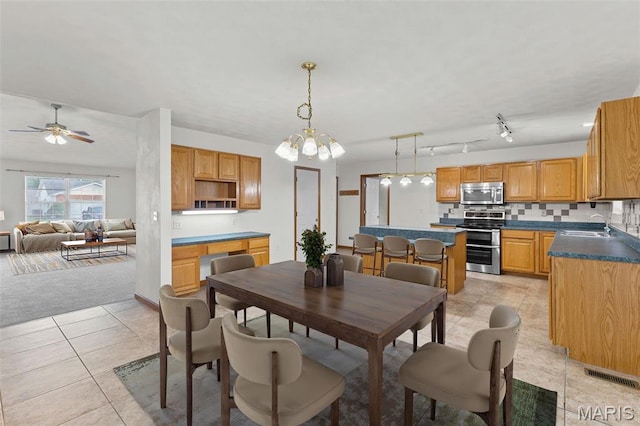 3779 Michael John Dr, Swansea, IL 62226 - dining room featuring light tile patterned floors, ceiling fan, and a chandelier