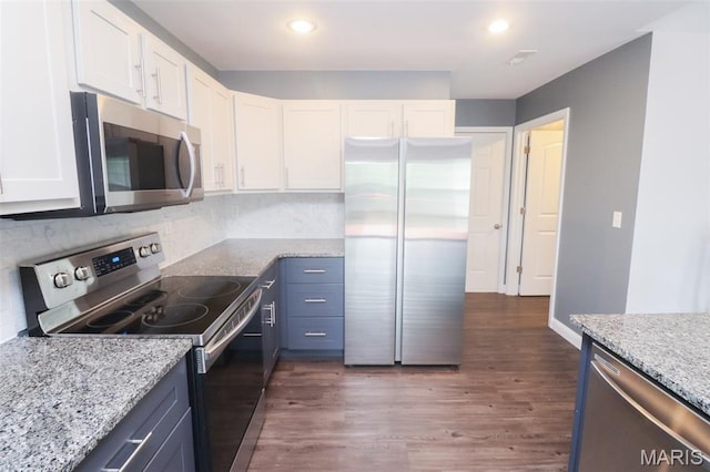 278 Settlers Pass, Waynesville, MO 65583 - kitchen with appliances with stainless steel finishes, white cabinetry, light stone counters, backsplash, and dark wood-type flooring