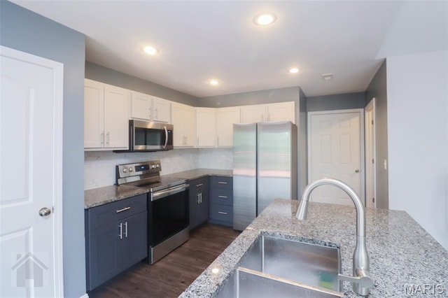 278 Settlers Pass, Waynesville, MO 65583 - kitchen featuring stainless steel appliances, white cabinetry, dark wood-style floors, light stone countertops, and recessed lighting