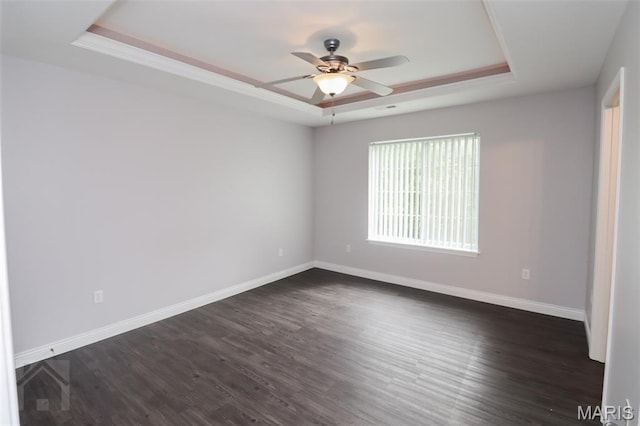 278 Settlers Pass, Waynesville, MO 65583 - spare room featuring a raised ceiling, a ceiling fan, and dark wood-style flooring
