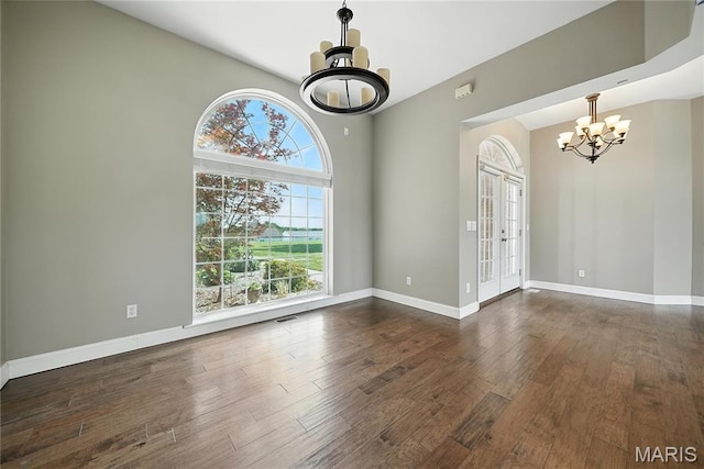 1408 Elm Tree Rd, Troy, MO 63379 - unfurnished room featuring a chandelier, plenty of natural light, dark wood-type flooring, and vaulted ceiling