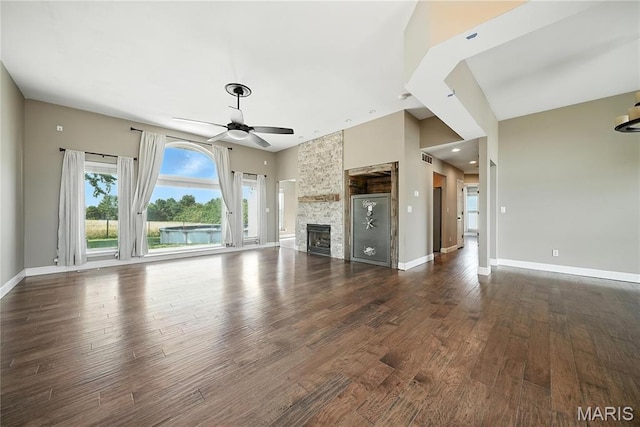 1408 Elm Tree Rd, Troy, MO 63379 - unfurnished living room featuring a ceiling fan, dark wood finished floors, a stone fireplace, and recessed lighting