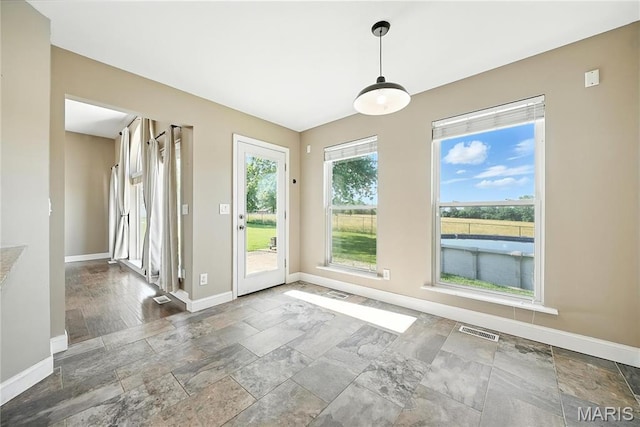 1408 Elm Tree Rd, Troy, MO 63379 - unfurnished dining area with stone tile floors and baseboards