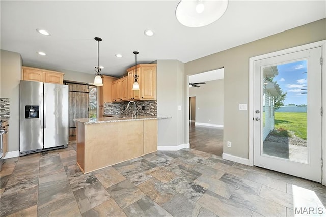 1408 Elm Tree Rd, Troy, MO 63379 - kitchen featuring stainless steel fridge with ice dispenser, light brown cabinets, stone tile floors, tasteful backsplash, and plenty of natural light