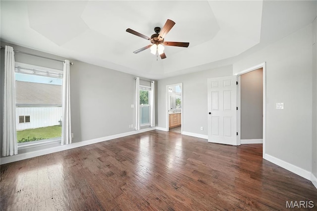1408 Elm Tree Rd, Troy, MO 63379 - spare room with ceiling fan, a tray ceiling, and dark wood-style flooring