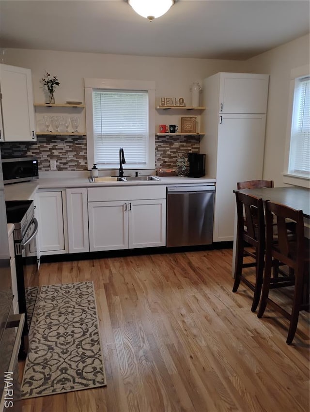131 Sackett St, Licking, MO 65542 - kitchen with open shelves, stainless steel appliances, healthy amount of natural light, and backsplash