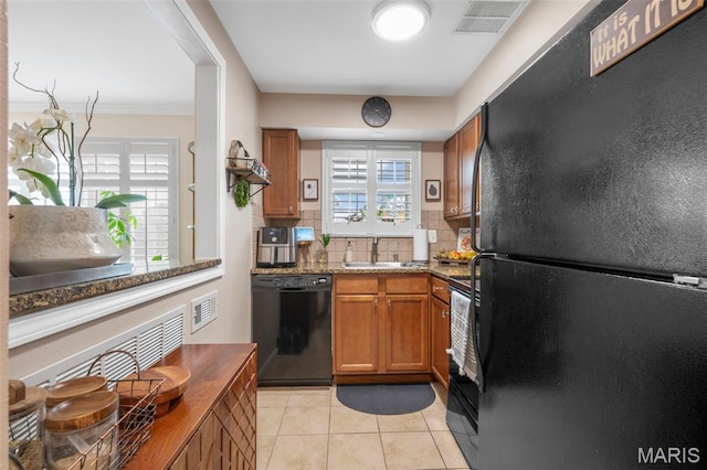 946 Marshall Ave Unit A, Webster Groves, MO 63119 - kitchen featuring black appliances, brown cabinetry, decorative backsplash, light tile patterned flooring, and stone countertops