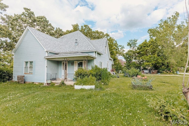 402 N Chestnut St, Richland, MO 65556 - view of front of home featuring covered porch, roof with shingles, and a front yard