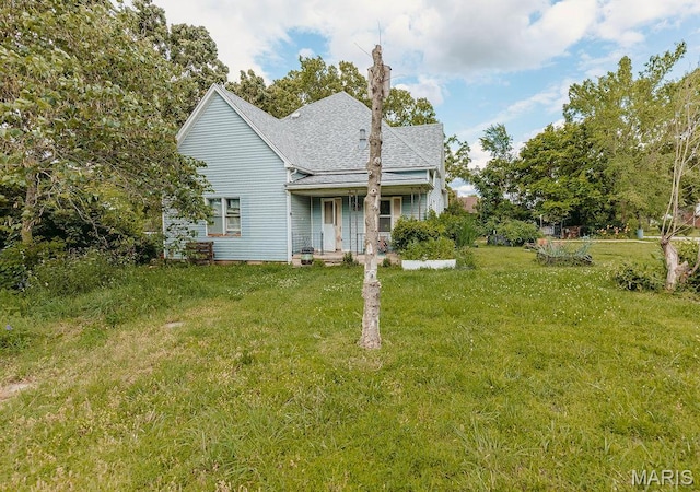 402 N Chestnut St, Richland, MO 65556 - view of front of property with a front lawn, covered porch, and a shingled roof