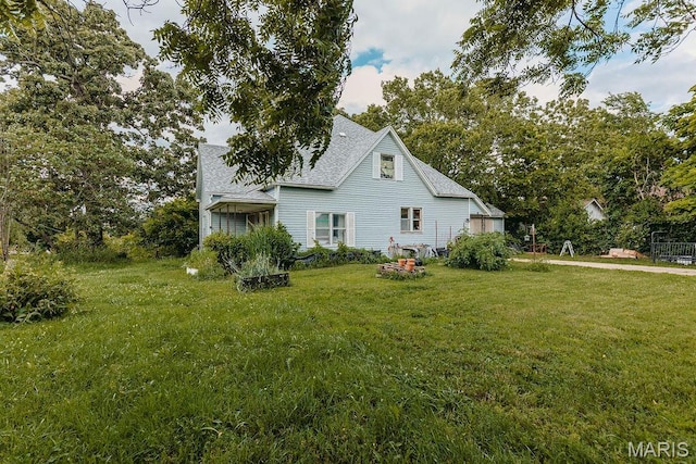 402 N Chestnut St, Richland, MO 65556 - view of home's exterior featuring a yard and roof with shingles