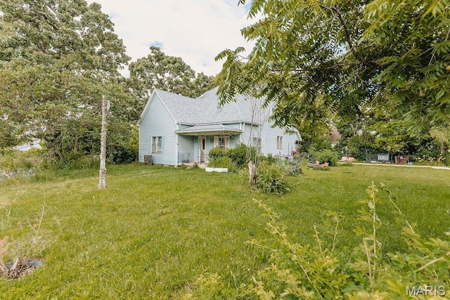402 N Chestnut St, Richland, MO 65556 - view of side of property featuring a lawn and roof with shingles