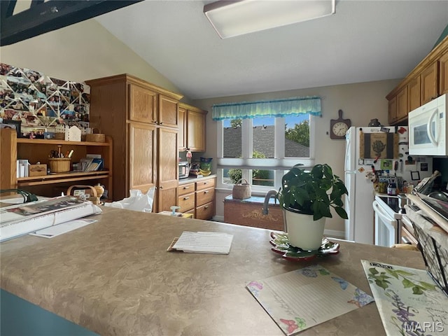 3 Crabapple Ln, Glen Carbon, IL 62034 - kitchen with white microwave, lofted ceiling, and brown cabinetry
