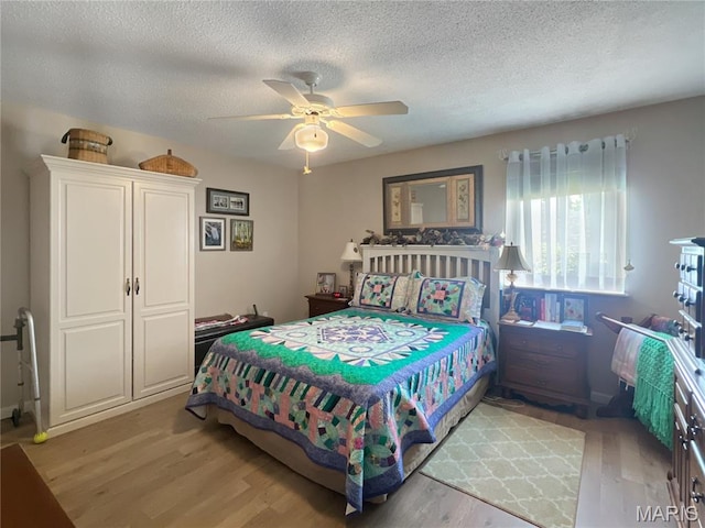 3 Crabapple Ln, Glen Carbon, IL 62034 - bedroom with light wood-style flooring, a textured ceiling, and ceiling fan