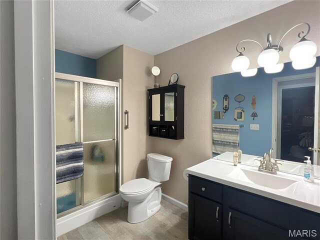 3 Crabapple Ln, Glen Carbon, IL 62034 - bathroom featuring a textured ceiling, vanity, wood finished floors, and a stall shower