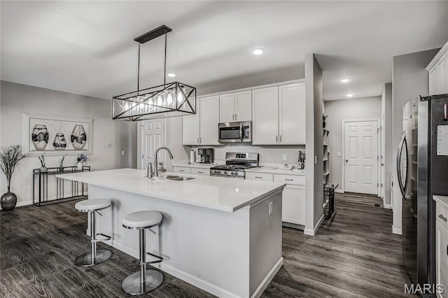 191 Noahs Mill Dr, Lake St Louis, MO 63367 - kitchen with appliances with stainless steel finishes, a kitchen bar, a center island with sink, white cabinets, and light countertops
