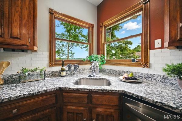 5 Sherman Ct, Hillsboro, MO 63050 - kitchen with stainless steel dishwasher, light stone countertops, and decorative backsplash
