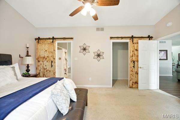 5 Sherman Ct, Hillsboro, MO 63050 - bedroom featuring a barn door, carpet, a ceiling fan, and a spacious closet