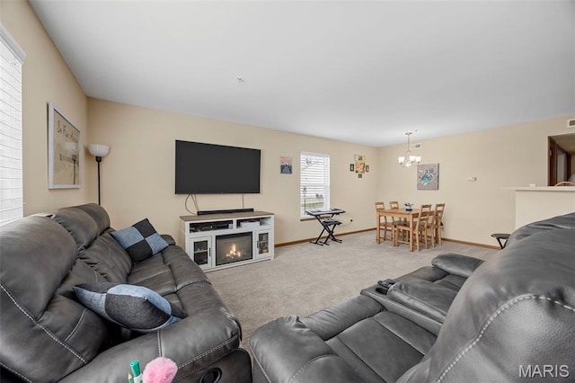 628 Homerun Dr Unit 11N, Ofallon, MO 63366 - carpeted living room featuring a chandelier and a glass covered fireplace