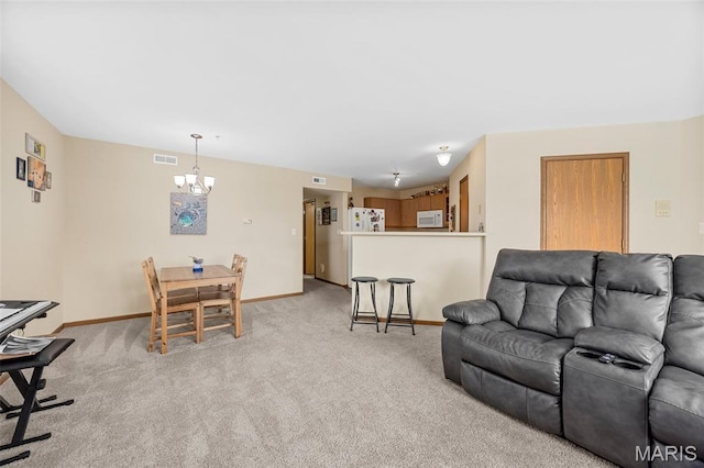 628 Homerun Dr Unit 11N, Ofallon, MO 63366 - living area featuring a chandelier and light carpet